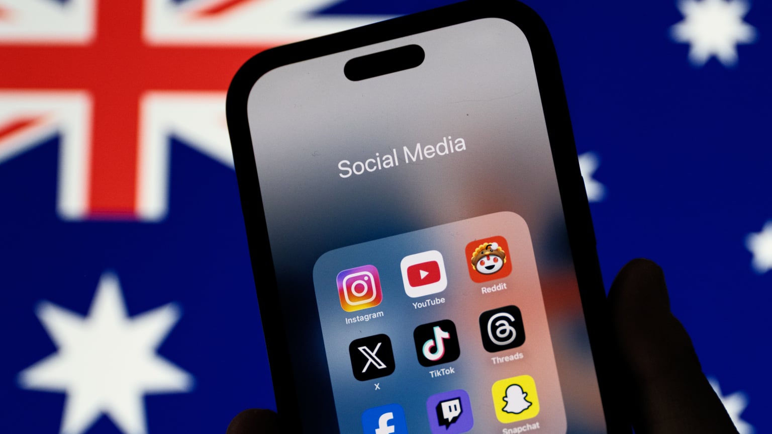 social media apps on phone screen, australian flag in the background