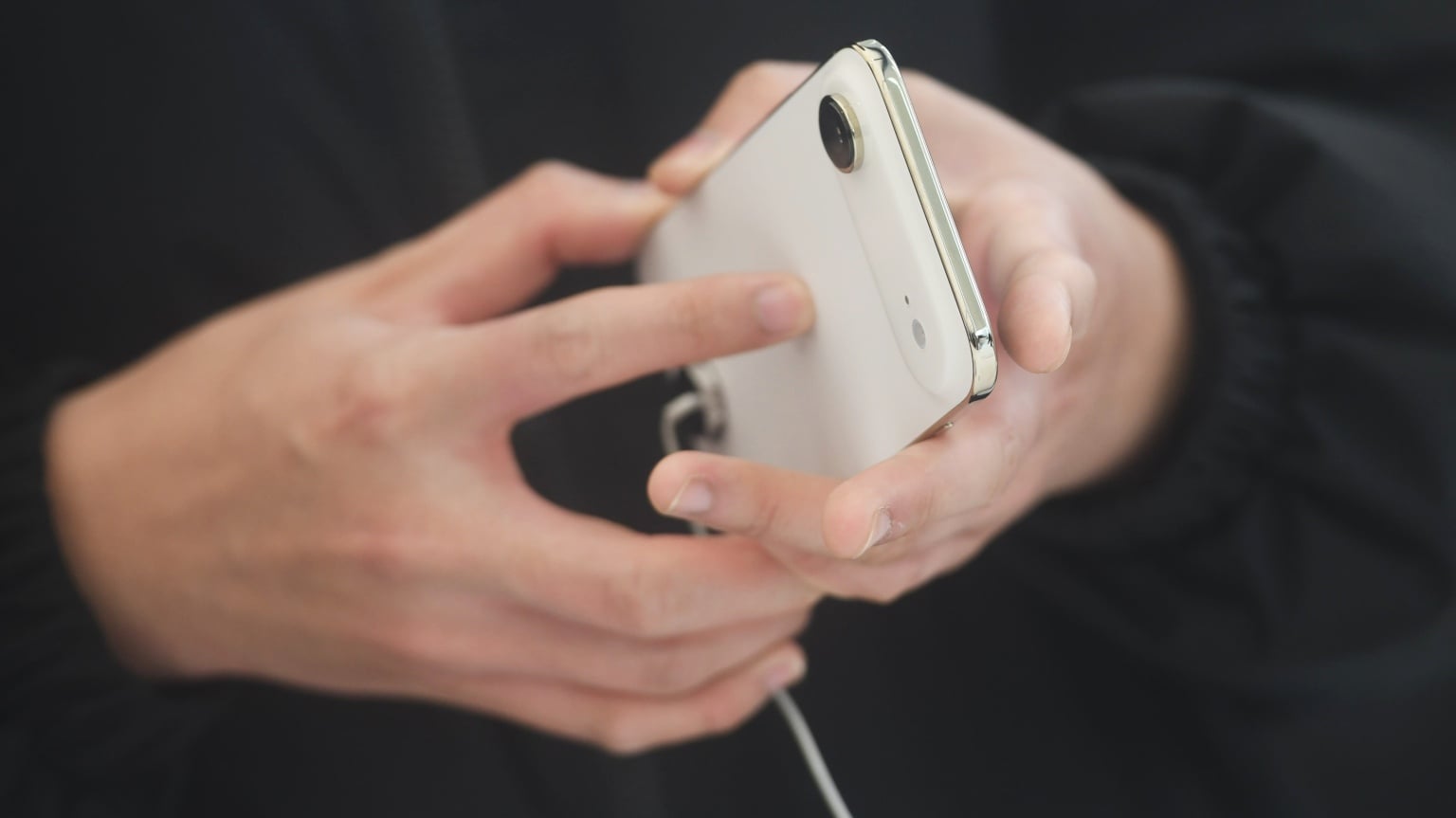 A customer holds an iPhone Air at an Apple store