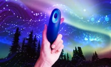 A person holding a Moonbird device against a starry sky.
