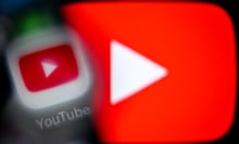 A blurry YouTube app icon over a large glowing YouTube play logo.