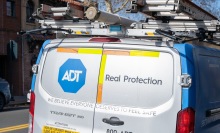 Logo for security company ADT on installation van parked on street