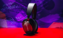 bowers & wilkins px8 s2 headphones stand up in front of purple background