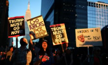 A group of protesters, some wearing Knicks jerseys, hold up anti-Trump signs outside MSG.