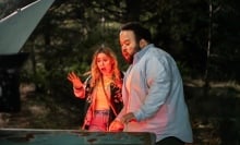 Maria Bakalova and Zach Cherry look terrified opening a car trunk in a still from "All Night Wrong."