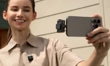 person filming themself with dji mic mini plugged into phone and on shirt