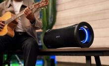 Sony ULT field 7 speaker next to man playing guitar