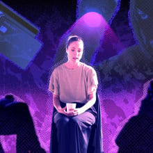 Woman sits in front of people listening empathetically.