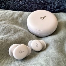 lilac sleep a30 special earbuds on light blue comforter in front of dark blue pillow