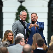 RFK Jr. takes a selfie with an event attendee on the White House lawn. 