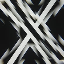 A kaleidoscopic picture of a black and white X logo.