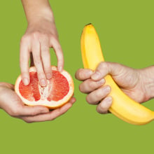 Banana and grapefruit in hands isolated on a green background as a symbol of male and female masturbation. 