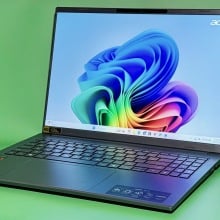 Acer Aspire 16 AI laptop open to Windows 11 homescreen on green background