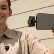 person filming themself with dji mic mini plugged into phone and on shirt
