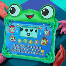Toy Story 5 Explore & Learn Lilypad appears surrounded by children's hands reaching for the tablet.