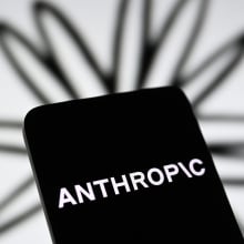 the Anthropic logo is seen displayed on a smartphone screen