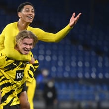 Dortmund's Norwegian forward Erling Braut Haaland celebrates with Dortmund's English midfielder Jude Bellingham (top) after the German first division Bundesliga football match FC Schalke 04 vs Borussia Dortmund in Gelsenkirchen, western Germany, on February 20, 2021