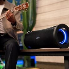 Sony ULT field 7 speaker next to man playing guitar