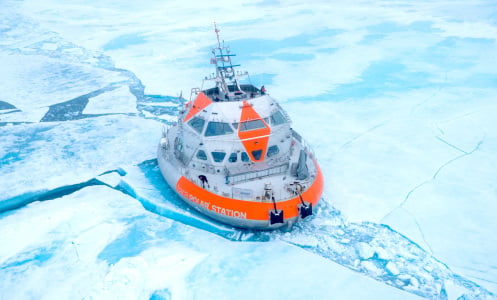 A drone image shows the Tara Polar Station up in the Arctic, surrounded by ice