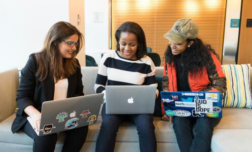 Trio looking at laptops