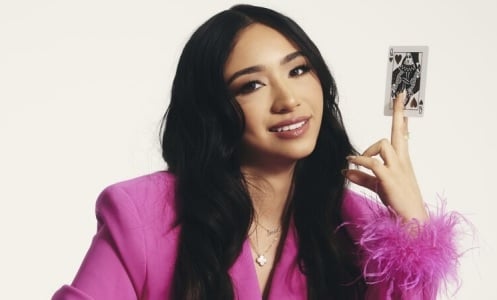 anna deguzman holding a card in her hand