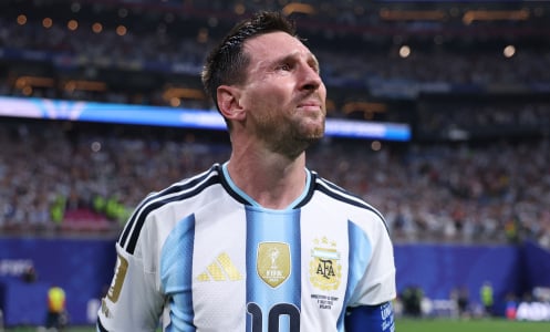 Lionel Messi stands on the pitch during a World Cup match