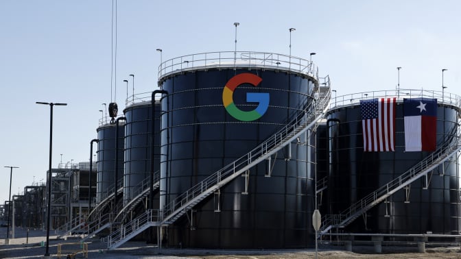 Two large metal structures emblazoned with the Google logo and the Texas state flag. 