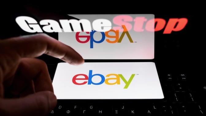 the eBay logo appears on a smartphone screen with the GameStop logo in background