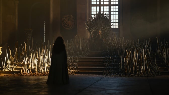 A still from "House of the Dragon" showing Aemond on the throne with Alicent attending.