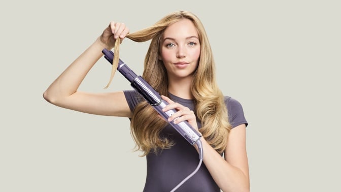 person styling hair with shark flexstyle ioncurl