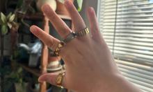 A person wearing four smart rings on one hand.