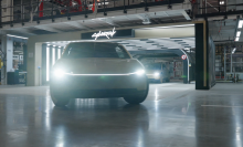 A Cybercab rolls out of the Tesla garage.