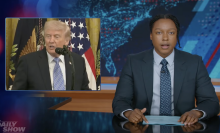 A man sits behind a talk show desk. In the top left is an image of the president.