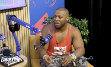 Man sits in chair being interviewed