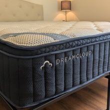 the dreamcloud premier hybrid mattress in a bedroom with no sheets