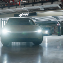 A Cybercab rolls out of the Tesla garage.