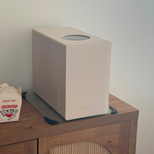 Dreame food waste disposer, takeout container, and decor sitting on wooden credenza in living space