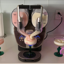 Ninja Slushi Twist after making strawberry and pineapple frosé, two margarita glasses, and a neon light on kitchen countertop
