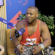 Man sits in chair being interviewed