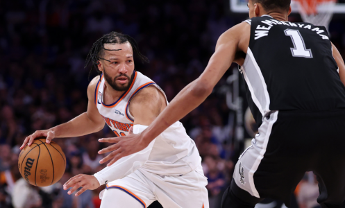 Jalen Brunson dribbling basketball facing Victor Wembanyama