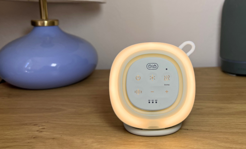Canopy Sound Machine + Aroma lit up on a nightstand
