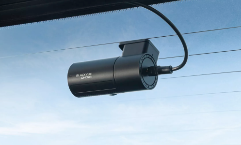 A BlackVue dashcam attached to a windshield.