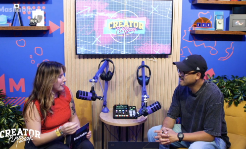 Two people talking in a podcast studio