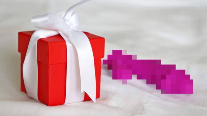 pixelated sex toy next to a gift box with a bow