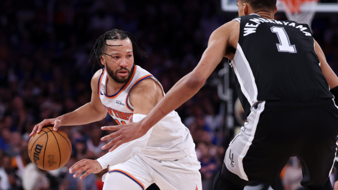 Jalen Brunson dribbling basketball facing Victor Wembanyama