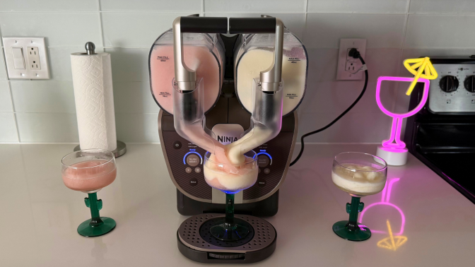 Ninja Slushi Twist after making strawberry and pineapple frosé, two margarita glasses, and a neon light on kitchen countertop