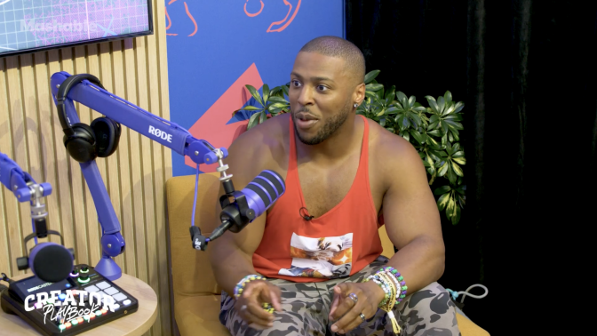 Man sits in chair being interviewed