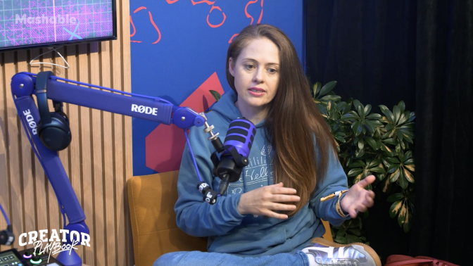 Woman talking into podcast mic 