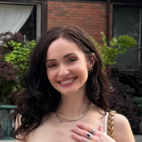 Leah smiling in front of brick building